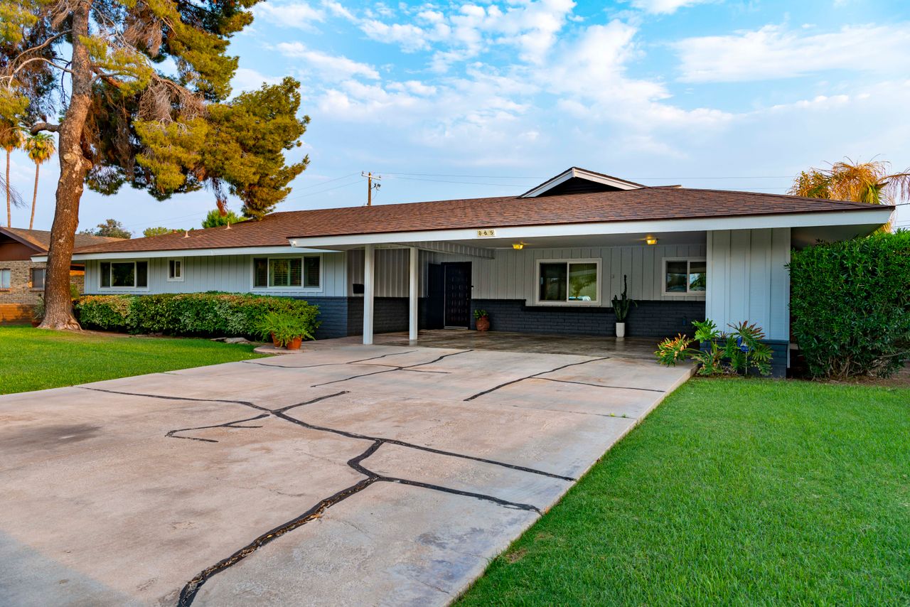 services-img Elegant suburban bungalow with a well-manicured lawn and spacious driveway.