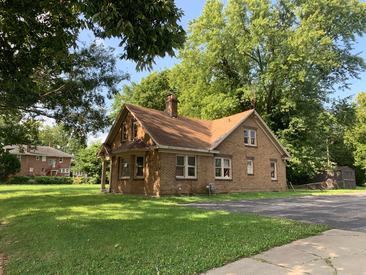 Charming brick house surrounded by trees in a quiet Decatur neighborhood. Perfect for real estate and lifestyle imagery.
